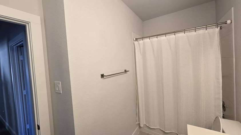 Powder room with floor-to-ceiling wood slat backdrop, under-cabinet lighting by EZ Innovation LLC, Houston handyman
